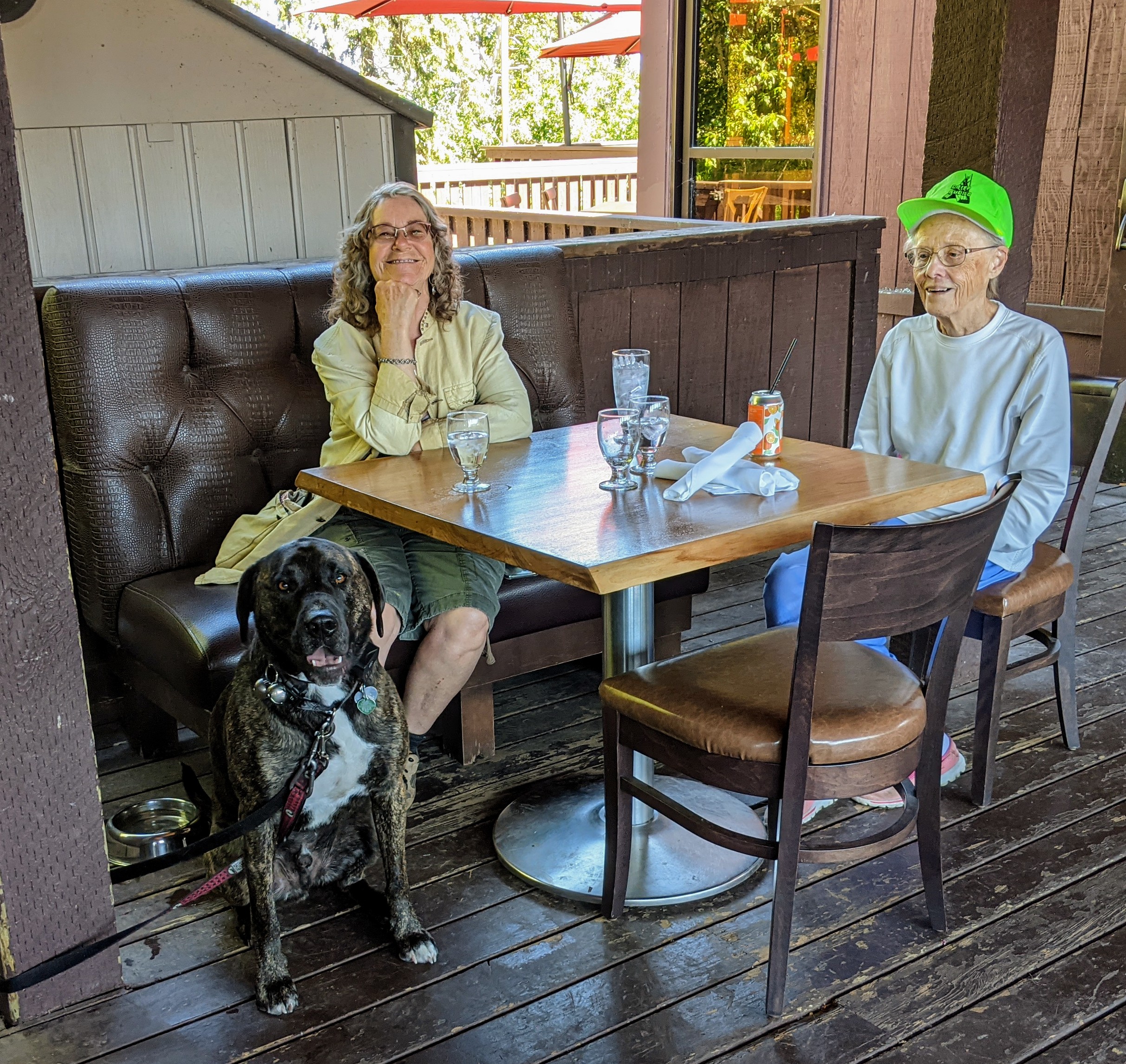 Two ladies and their dog enjoying a cool drink on Heritage Ranch's patio