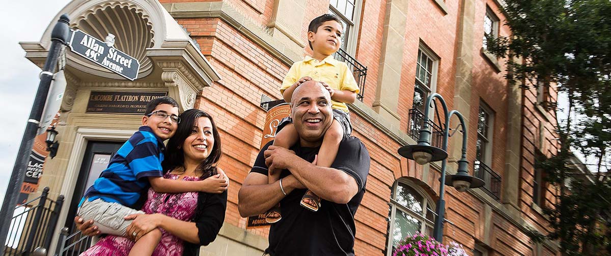 Family in front of the Flat Iron Building in Lacombe. 