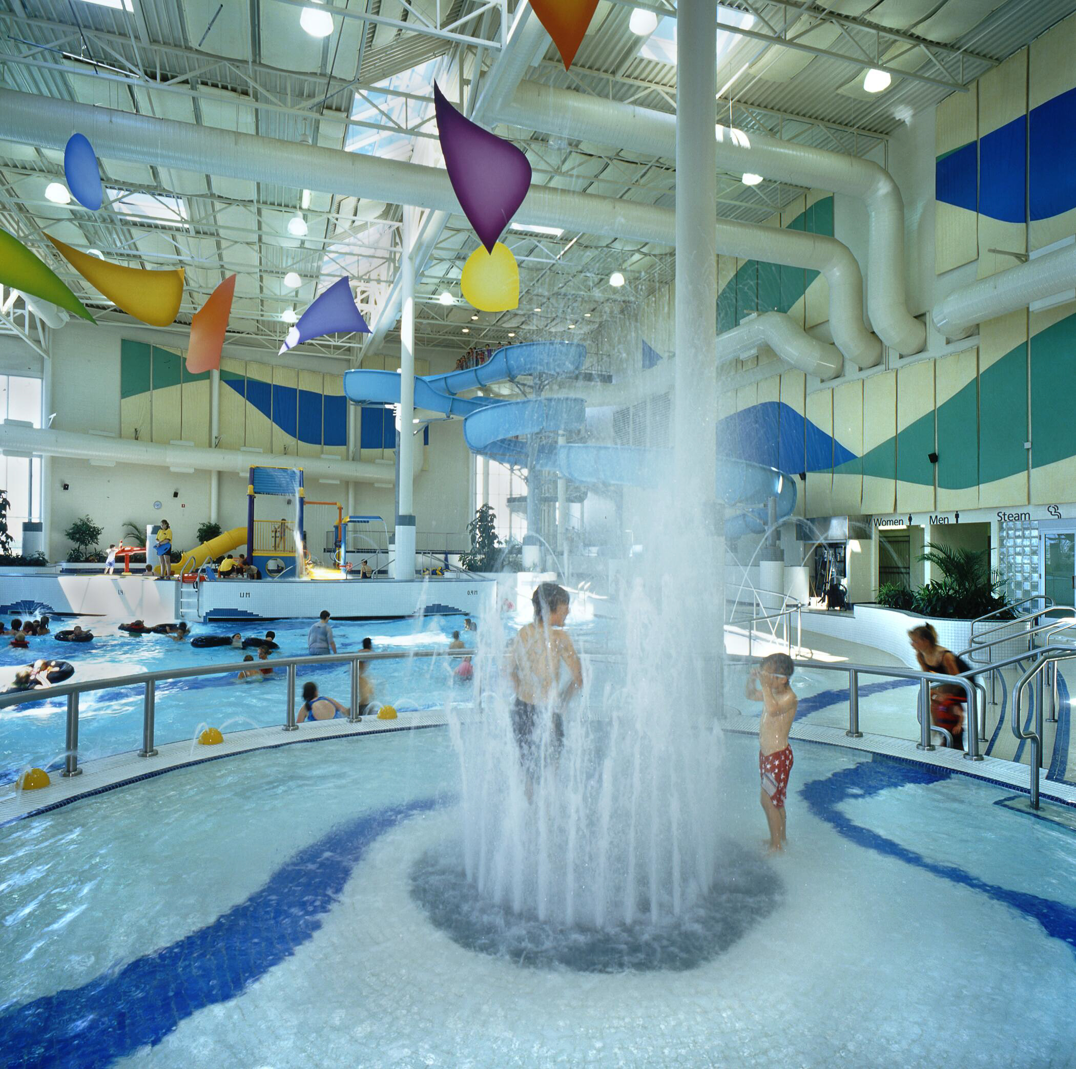 Young boy enjoying the splash park at Kin Kanyon on a beautiful summer day.