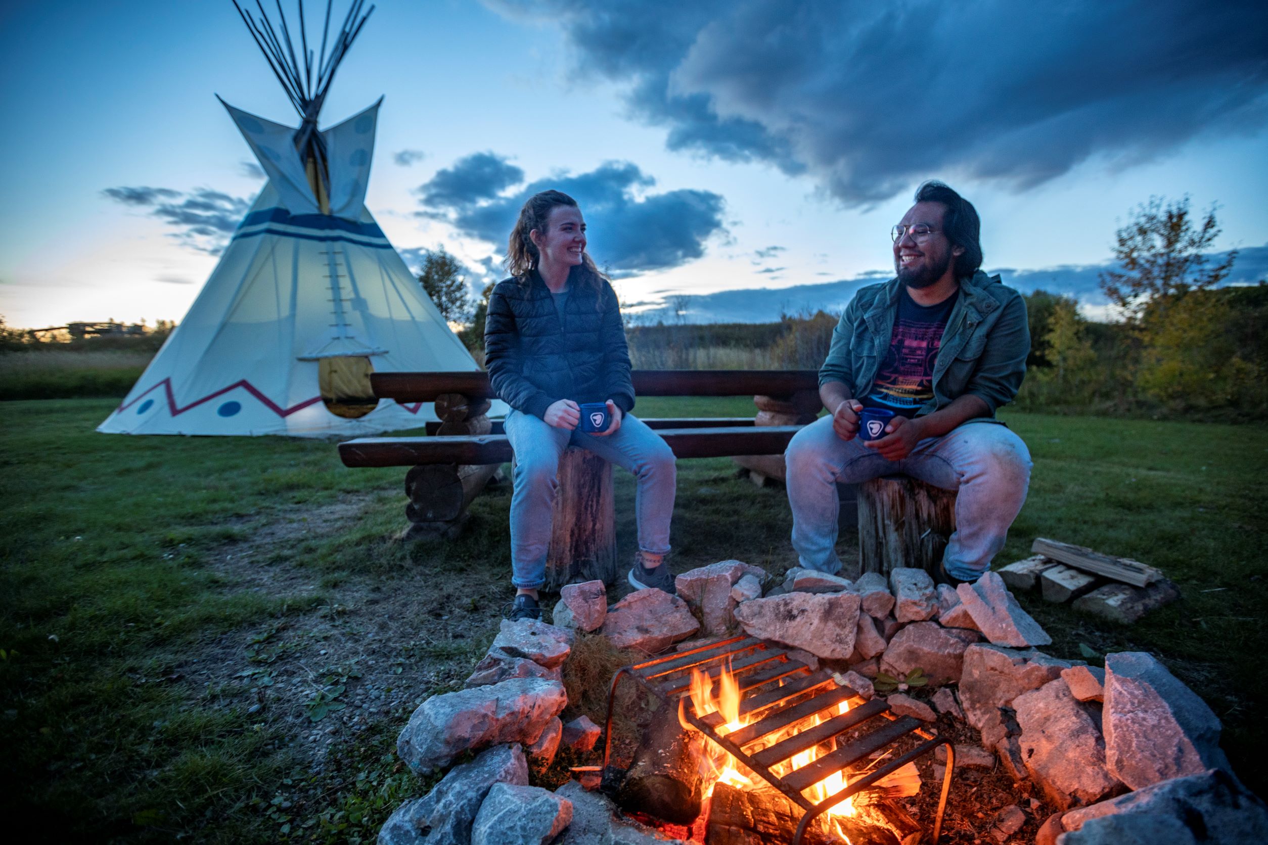 A family enjoying a campfire at the Rocky Mountain House Historic Site