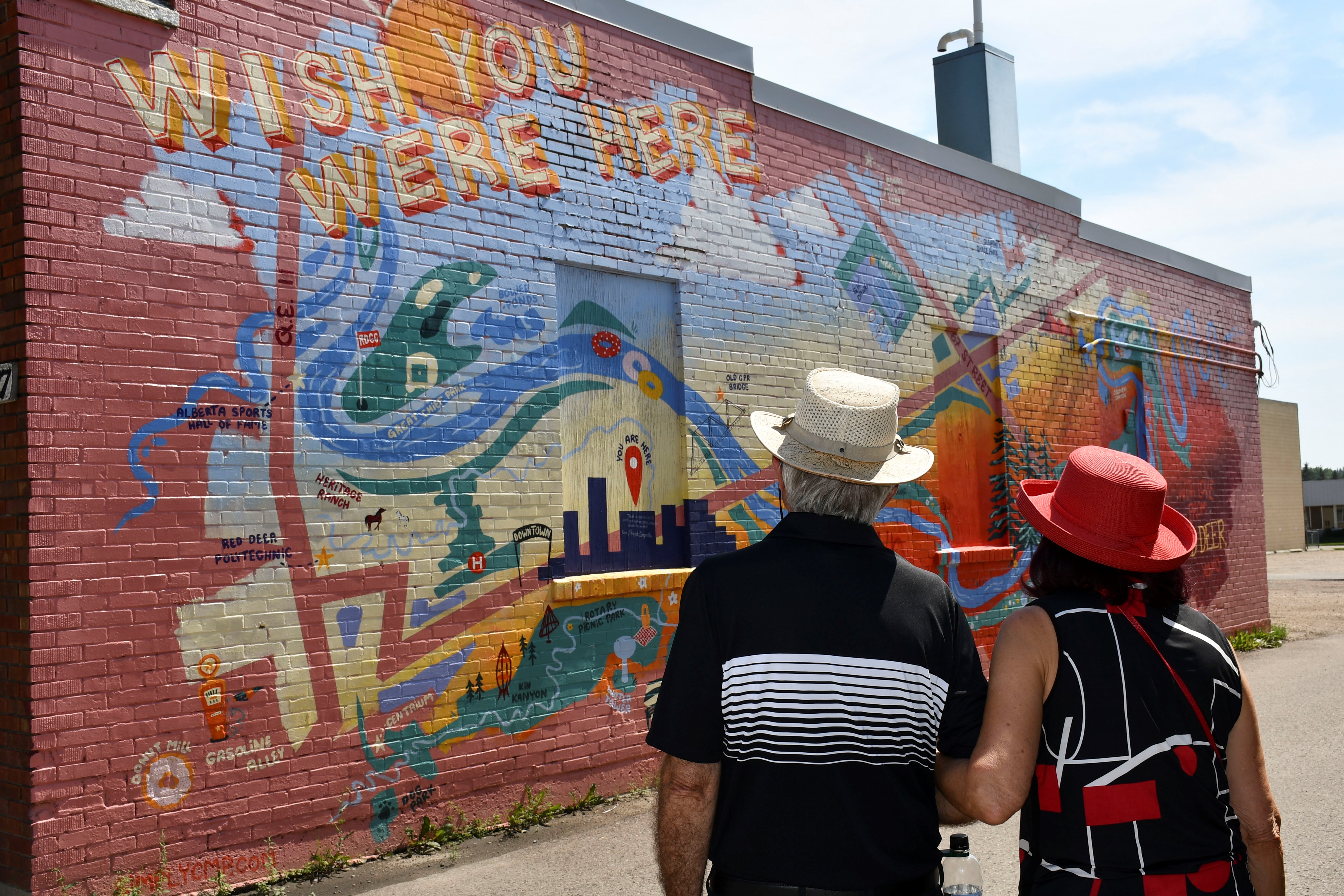 Ken and Judy observing a mural in downtown Red Deer