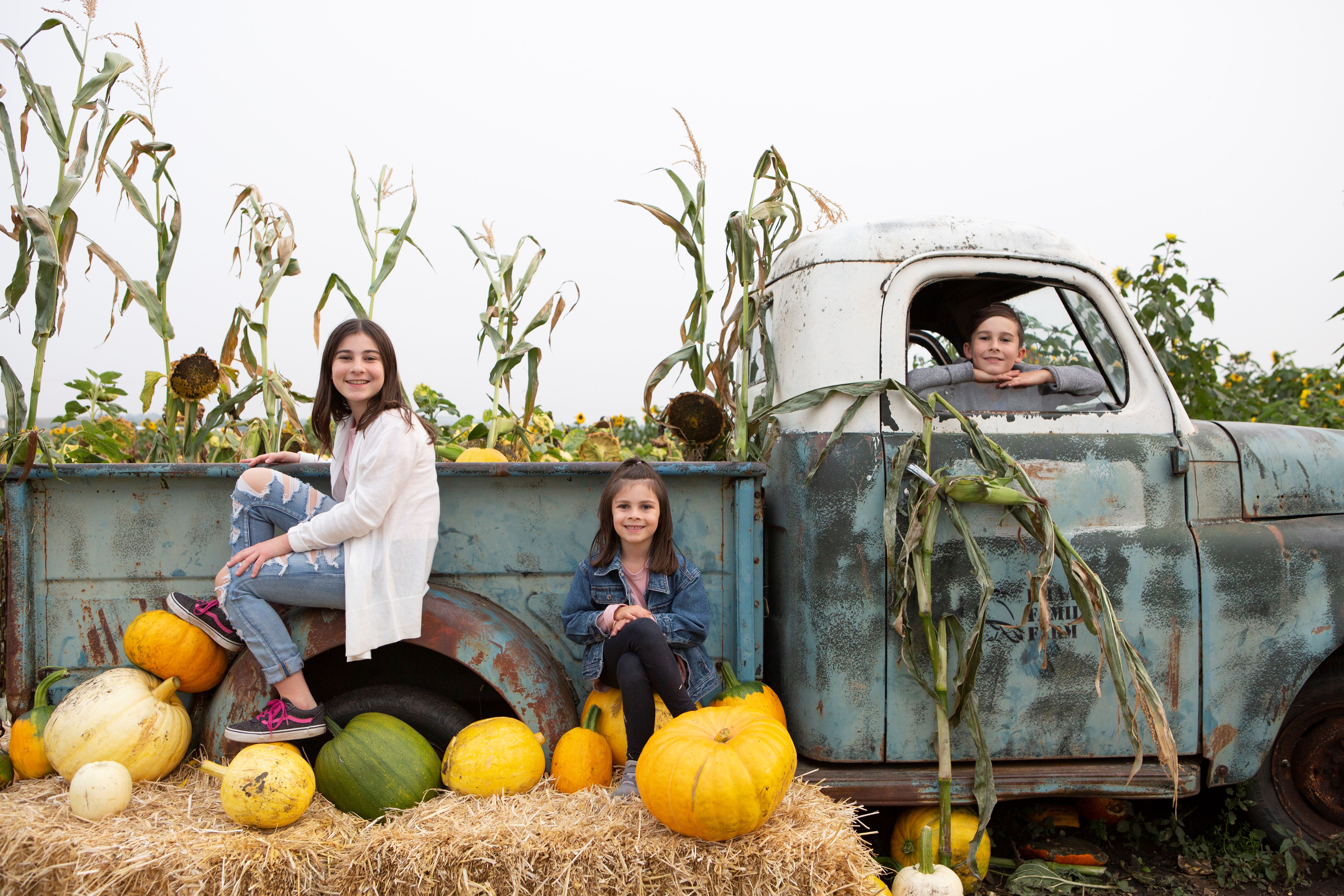 family enjoying pumpkin days during fall at Kraay Family Farm