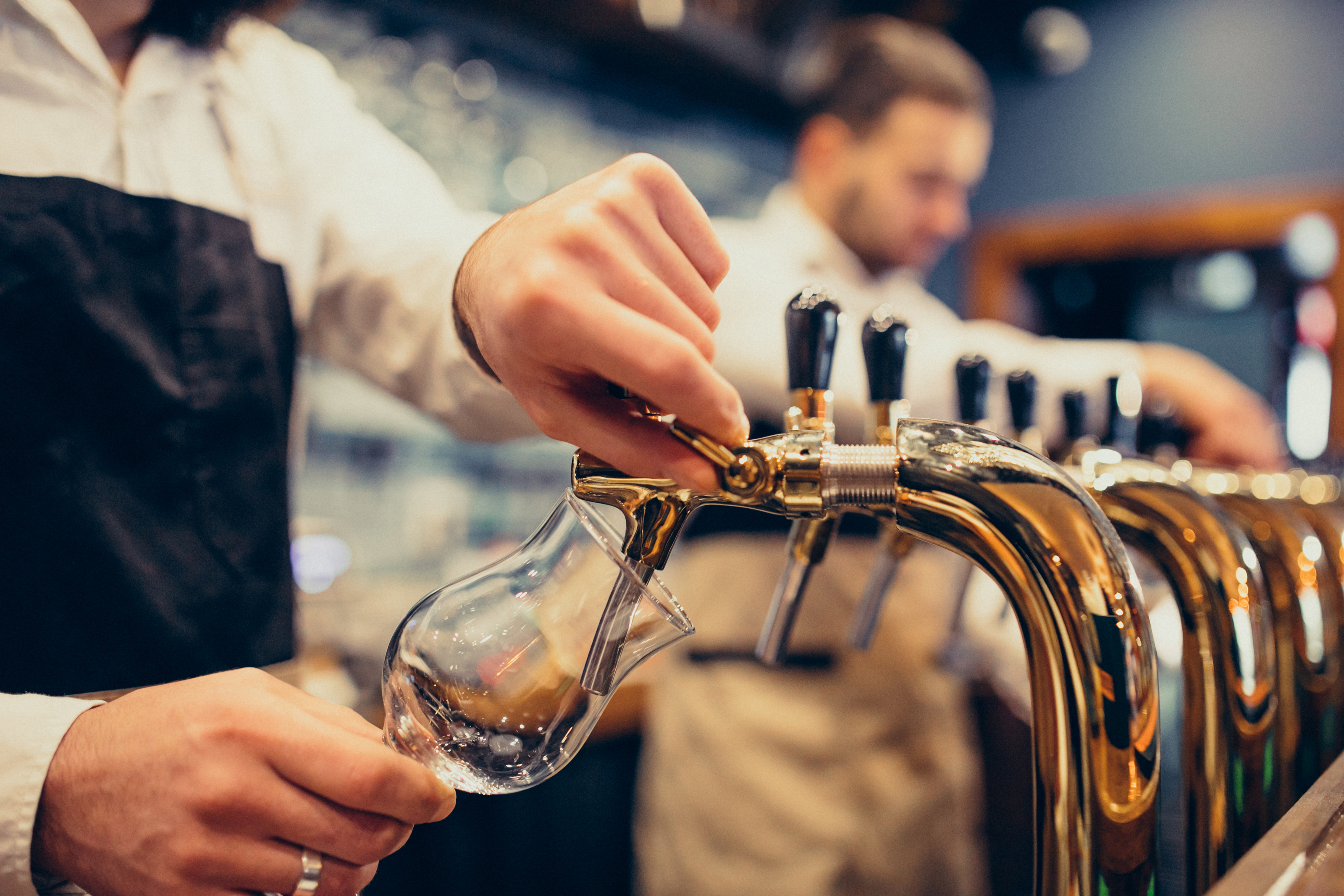 Bartenders pouring beer. 